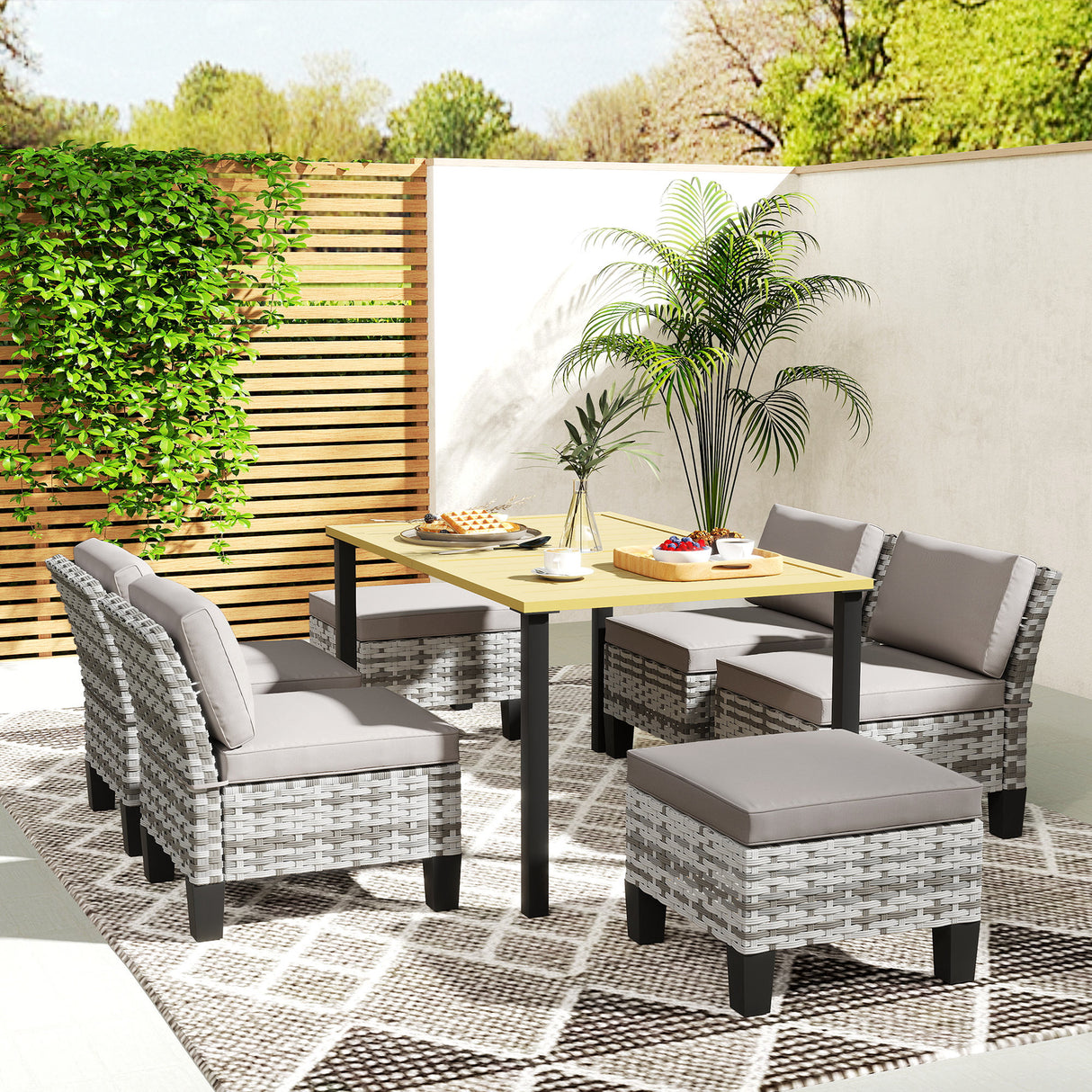 Steel 7 Pieces Garden Dining Set With 4 Poly Rattan Armchairs And 4 Footstools - Velmora