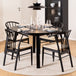 Wooden Dining Table Round Extending With 4 Cassandra Black Dining Chairs - Montreux